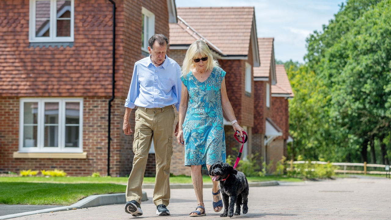 The Bagleys walking their dog around the development