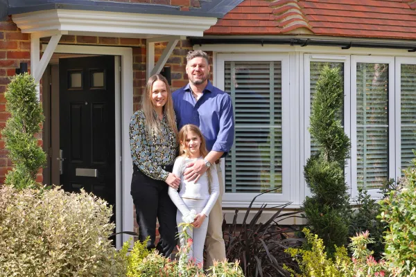 Elivia Homes buyers standing outside their front door 