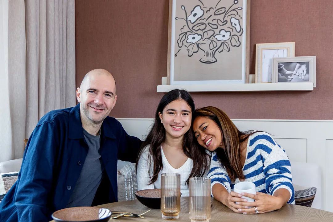David, Mattika & Jessica Bano sat around a dining room table smiling