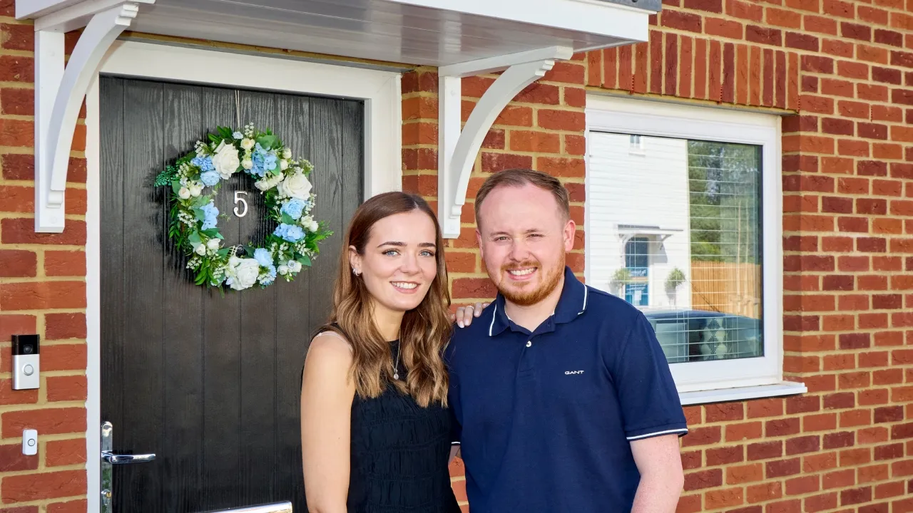 Becca & Tom in front of Meadows home