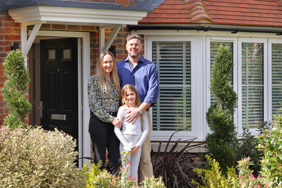 Elivia Homes buyers standing outside their front door 